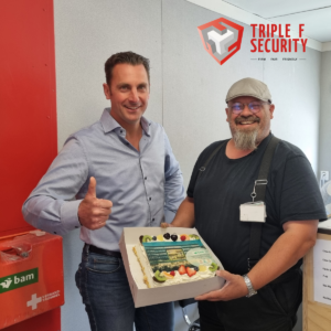 In the photo, executor Dennis receives the End Project Cake from Marco